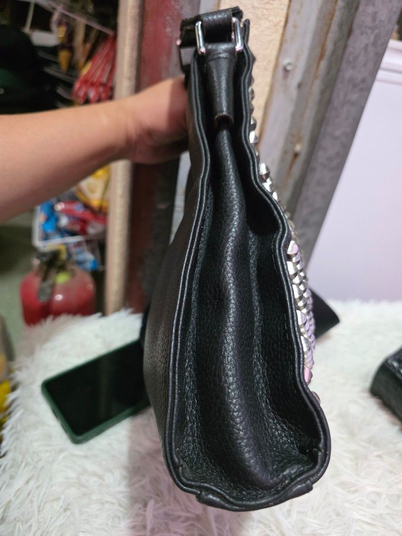 Black Leather Studded Crossbody Bag with Silver Hardware (Category: Cross-body Bags) located in Lemery. Submitted by venus23 (Listing ID 1464668771, Image 3). Description: - Black leather crossbody bag - Covered in silver studs all over the front - Zip pocket on the back - Silver hardware details - Adjustable strap - Makes a cool statement piece -Genuine leather.