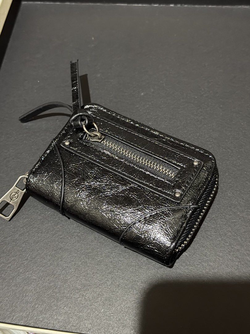 Black Leather Zip Around Wallet with Front Zip Pocket (Category: Wallets & Card holders) located in Manila. Submitted by medv27 (Listing ID 1464602480, Image 1). Description: - Genuine black leather wallet - Secure zip-around closure - Convenient front zippered pocket - Multiple interior card slots and compartments for organization - Unique logo detail on zipper pull - Detachable side strap for easy carrying - Ideal for keeping your essentials ti