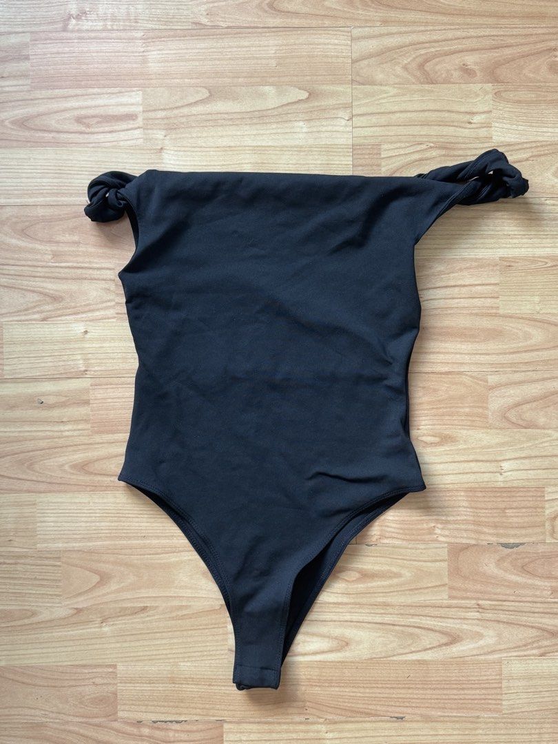 Black Off-Shoulder Bodysuit with Twisted Straps (Category: Sleeveless) located in Rizal. Submitted by suuhhhbrinuh (Listing ID 1464624810, Image 1). Description: - Black off-shoulder bodysuit - Features stylish twisted straps - Flattering high-cut leg design - Versatile for layering or wearing alone - Comfortable and fashionable - Ideal for beach or casual outfits.