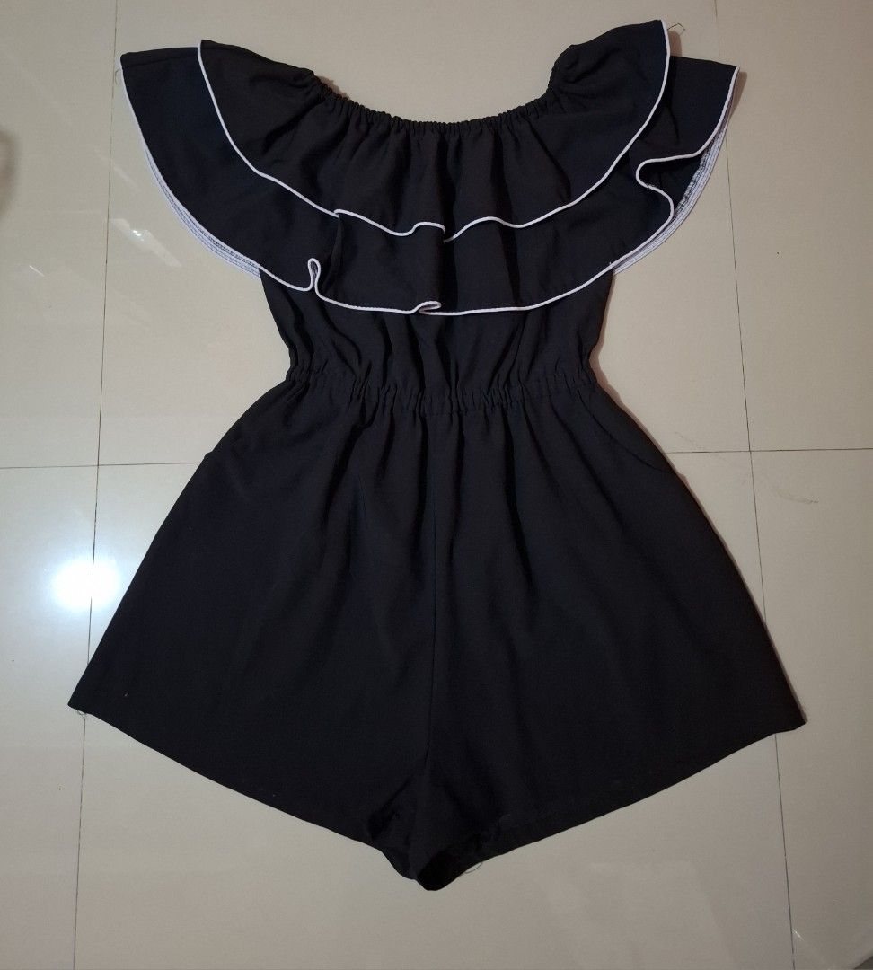 Black Off-Shoulder Ruffle Romper (Category: Rompers) located in Siniloan. Submitted by mari_881709 (Listing ID 1464618829, Image 1). Description: - Cute black romper - Off-shoulder design with ruffle top - White trim on ruffles for contrast - Elasticated waist for comfort - Versatile for casual days or nights out - Easy to wear and style.