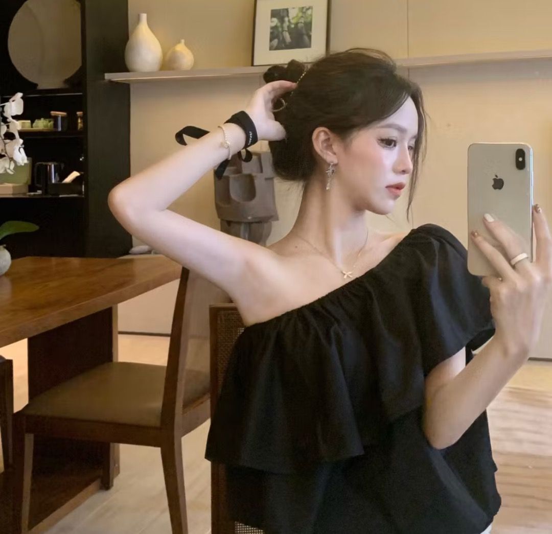 Black One Shoulder Ruffle Tiered Top (Category: Sleeveless) located in Santiago. Submitted by evrythngulove (Listing ID 1464579263, Image 2). Description: - Chic black one-shoulder top - Features multiple tiers of flowy ruffles - Comfortable elasticated neckline - Perfect for dressing up or down - Easily pairs with skirts or pants -fits small-large stretchable.
