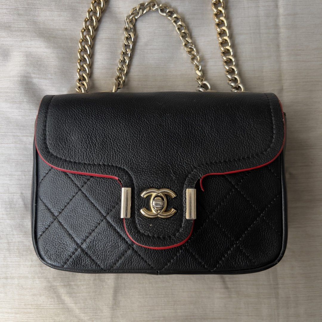 Black Quilted Leather Chain Bag with Red Trim (Category: Shoulder Bags) located in Pasig City. Submitted by jenscloset86 (Listing ID 1464668064, Image 1). Description: Measurement: Length: 8.5” Height: 6” Bottom width: 2.5” Strap: 40.5” • Soft and smooth leather • With visible damages (see photos for reference) •Cracking and detached red paint edges. • Need stitching in the lining. .