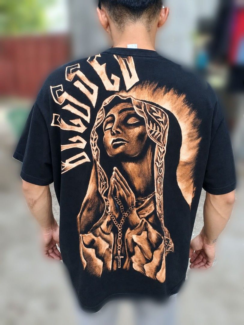 BLEACH ART - Praying Virgin Mary (Category: Shirts) located in Baliuag. Submitted by yin.yang_26 (Listing ID 1464606625, Image 1). Description: - Oversized black t-shirt - Large graphic print on back - Features Virgin Mary praying with rosary - Distressed, bleached-out effect on graphic - Perfect statement piece.