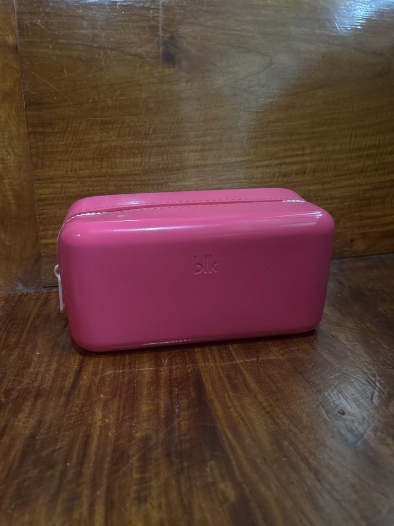 BLK Cosmetics Glossy Pouch (Category: Purses & Pouches) located in Manila. Submitted by declutter.diaries (Listing ID 1464577779, Image 1). Description: - pink cosmetics gloss pouch from BLK - Rectangular shape with zipper closure - Ideal for organizing makeup and toiletries - Easy-to-clean material - Compact size, perfect for travel or everyday use - Never used, only stuck at home.