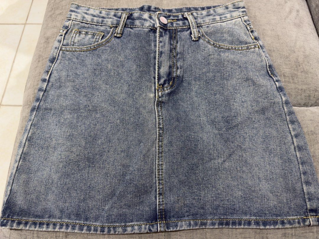 Blue Denim Mini Skirt (Category: Skirts) located in Taguig. Submitted by marietimebiscuit (Listing ID 1464725340, Image 1). Description: Blue denim mini skirt with a classic acid-wash finish. Front button closure and belt loops included. Features two front pockets and two back patch pockets. Contrast yellow stitching throughout. Straight cut silhouette that pairs easily with tees and crop tops..