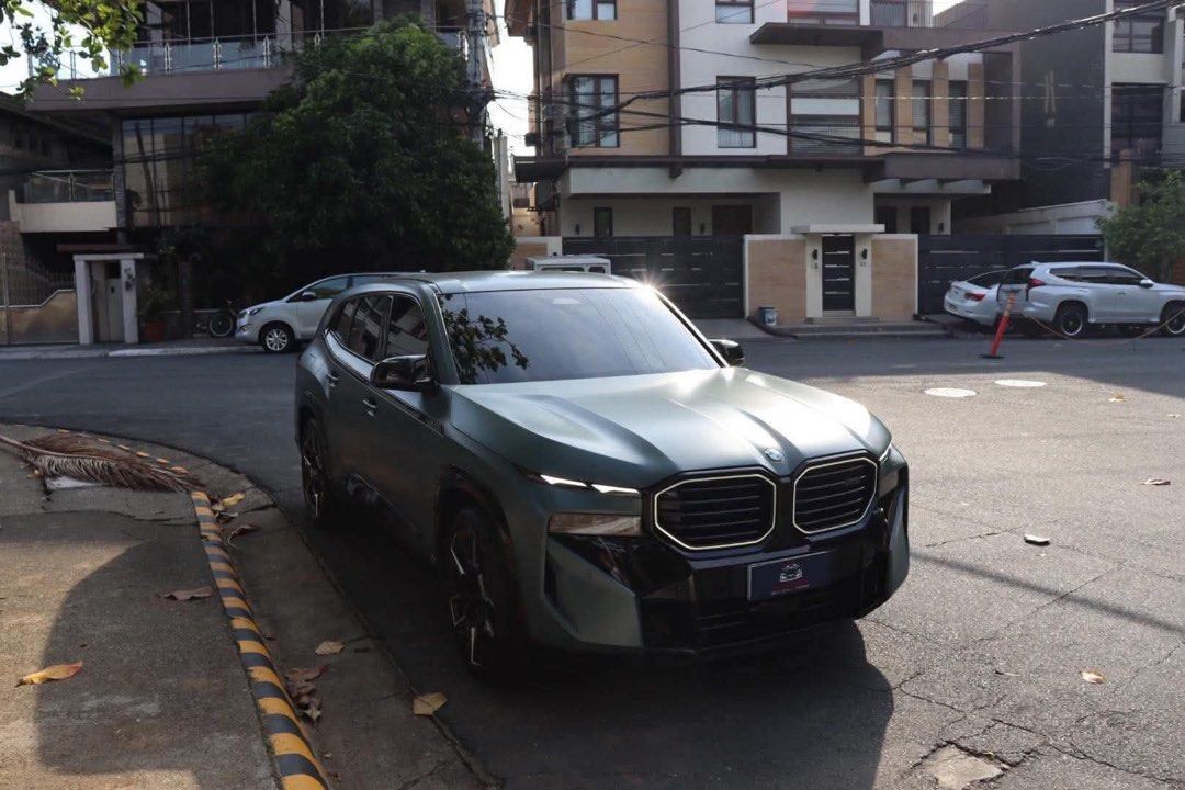 BMW XM Performance Auto (Category: Used Cars) located in Manila. Submitted by quality_cars (Listing ID 1464648936, Image 2). Description: 2024 BMW XM Performance 4.4L Twin Turbo V8 Engine Plug In Hybrid (PHEV) S68 644HP Flagship Model of BMW Cape York Green Exterior Blue Interior 12K Original Milage Only Cash Paid (with invoice from RSA) Casa Maintained 6 Ending Plate (No Coding) Registered 2027 Comes with Matte Paint Protection Film PPF Price: 9