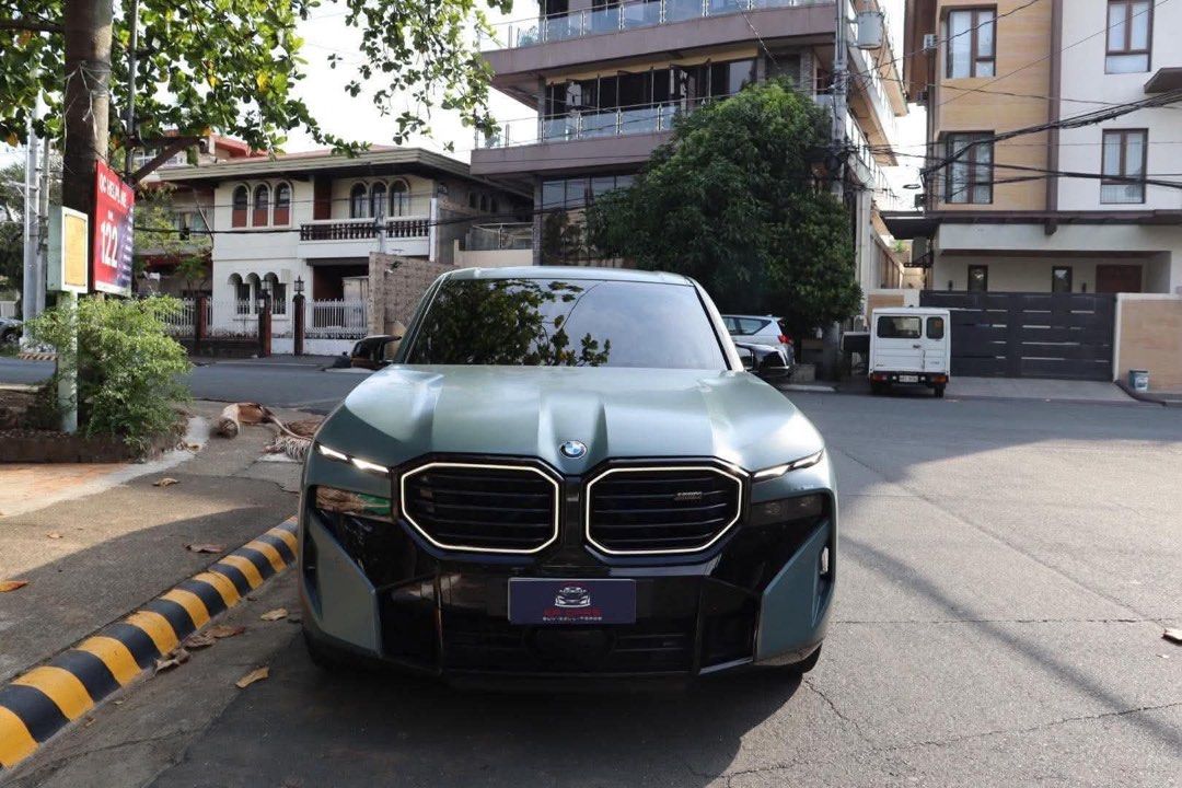 BMW XM Performance Auto (Category: Used Cars) located in Manila. Submitted by quality_cars (Listing ID 1464648936, Image 1). Description: 2024 BMW XM Performance 4.4L Twin Turbo V8 Engine Plug In Hybrid (PHEV) S68 644HP Flagship Model of BMW Cape York Green Exterior Blue Interior 12K Original Milage Only Cash Paid (with invoice from RSA) Casa Maintained 6 Ending Plate (No Coding) Registered 2027 Comes with Matte Paint Protection Film PPF Price: 9