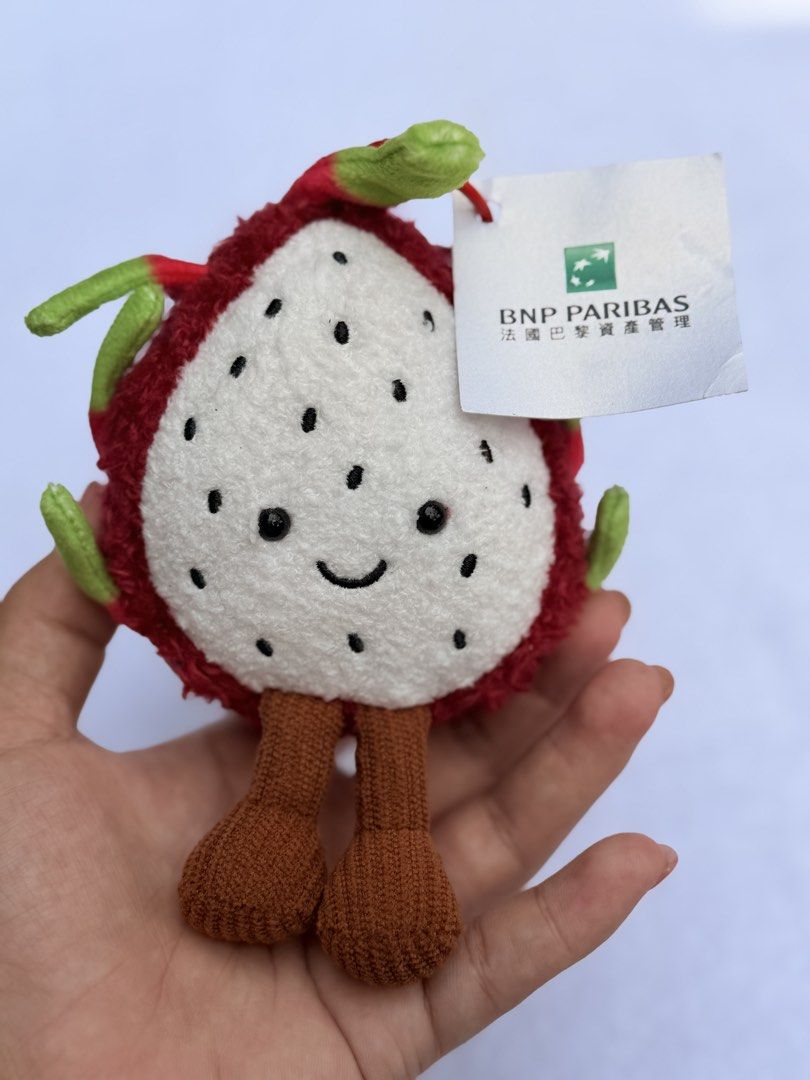 BNP Paribas Dragon Fruit Plush Keychain (Category: Plushies & Soft Toys) located in Baguio. Submitted by aalkharys (Listing ID 1464739100, Image 3). Description: - Brand new, never used with original BNP Paribas tag - Adorable dragon fruit plush design with textured red and green back - Detailed with charming stitched facial features - Features cute brown knitted dangling legs - Perfect accessory for keys, bags, or as a gift.