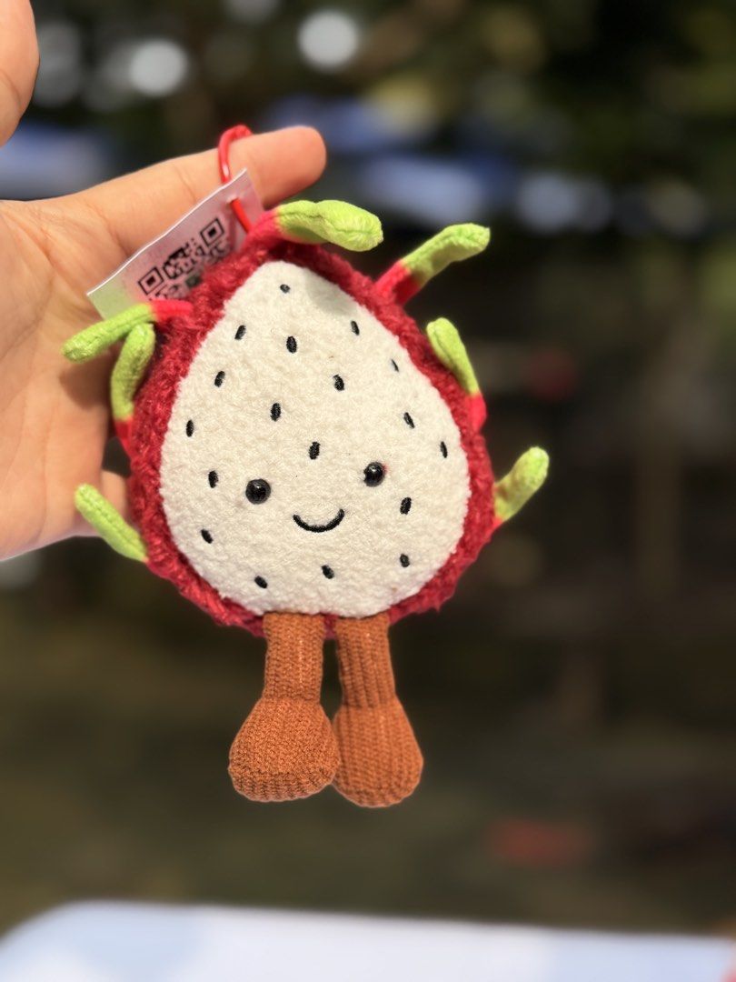 BNP Paribas Dragon Fruit Plush Keychain (Category: Plushies & Soft Toys) located in Baguio. Submitted by aalkharys (Listing ID 1464739100, Image 1). Description: - Brand new, never used with original BNP Paribas tag - Adorable dragon fruit plush design with textured red and green back - Detailed with charming stitched facial features - Features cute brown knitted dangling legs - Perfect accessory for keys, bags, or as a gift.