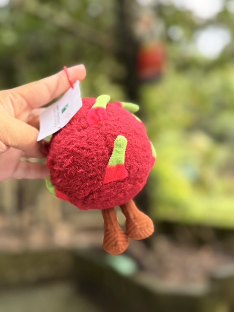 BNP Paribas Dragon Fruit Plush Keychain (Category: Plushies & Soft Toys) located in Baguio. Submitted by aalkharys (Listing ID 1464739100, Image 2). Description: - Brand new, never used with original BNP Paribas tag - Adorable dragon fruit plush design with textured red and green back - Detailed with charming stitched facial features - Features cute brown knitted dangling legs - Perfect accessory for keys, bags, or as a gift.