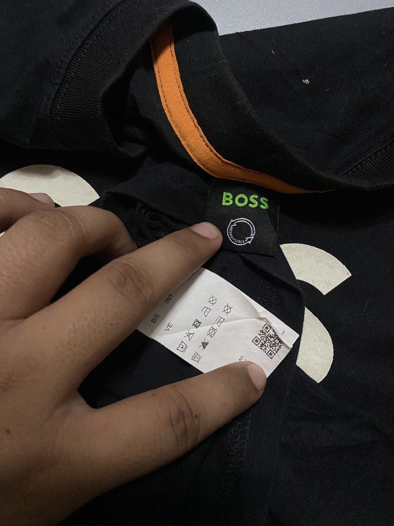 BOSS Black T-Shirt with White Logo (Category: Tshirts & Polo Shirts ) located in Silang. Submitted by kenneth_ukays (Listing ID 1464577509, Image 3). Description: - Classic black t-shirt from BOSS - Iconic white BOSS logo printed across the chest - Comfortable and stylish for everyday wear - Tagged size Medium (M) - Unique orange accent on the inner collar.