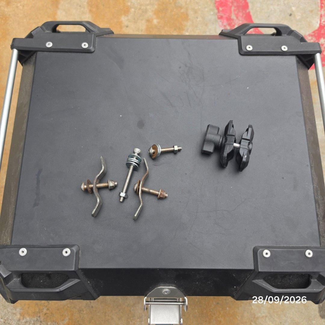 Box (Category: Motorcycle Accessories) located in Singapore. Submitted by sellsell.sold (Listing ID 1464698281, Image 3). Description: - Durable black motorcycle top/storage box - Interior features premium quilted diamond-pattern lining for extra protection - Secure locking latches with keys included - Comes with mounting base plate and hardware bolts/brackets - Condition: Used, sturdy and ready for installation - Meetup available at 64 commonwea