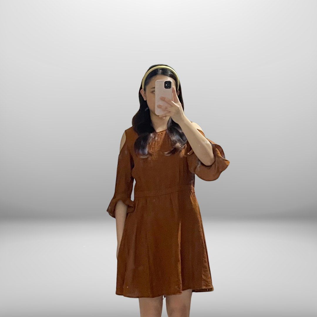 Brown cold shoulder mini dress with bell sleeves (Category: Dresses) located in Angeles City. Submitted by slay.the.day (Listing ID 1464720616, Image 1). Description: - Color: Brown - Style: Mini dress with a flowy skirt - Details: Cold shoulder cutouts and flared bell sleeves - Fit: Cinched waistline for a flattering silhouette - Fabric: Smooth and comfortable - Occasion: Perfect for casual days or casual outings - Condition: Excellent, no flaws