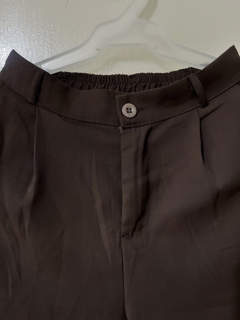 Brown high-waisted pleated trousers pants (Category: Trousers) located in Manila. Submitted by outtacloset (Listing ID 1464714065, Image 2). Description: - Color: Dark brown - Fit: Straight leg with front pleats - Waist: Button closure with elastic at the back for extra comfort - Style: Versatile, easy to match for both work and casual days - Condition: Clean fabric, rich deep shade.