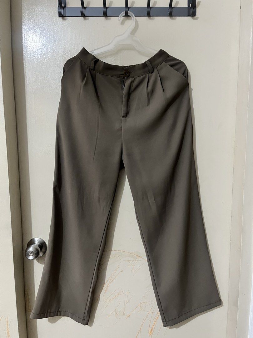 Brown Pleated Wide Leg Trousers (Category: Trousers) located in Manila. Submitted by outtacloset (Listing ID 1464714189, Image 1). Description: - Color: Olive Green - Style: Wide-leg trousers with front pleats - Closure: Button and zipper - Features: Belt loops and clean fabric with neat stitching - Fit: Relaxed through the legs - Occasion: Perfect for casual days or office wear.