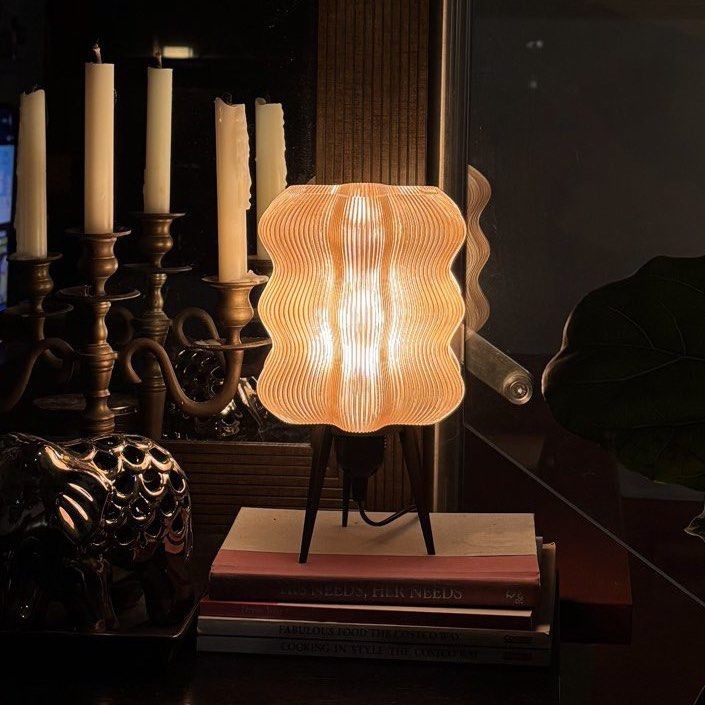 Brown Wavy Lamp (with Ikea LED bulb) (Category: Lighting) located in Mandaluyong City. Submitted by taag_ (Listing ID 1462877599, Image 1). Description: - Brand new, comes in a box and paper bag - Translucent light brown - 18cm L x 18 cm W x 28 cm H - 3D printed, please allow minimal imperfections - Comes with an Ikea E27 Solhetta LED bulb (warm light) Licensed design by Eris https://makerworld.com/@eris2000.