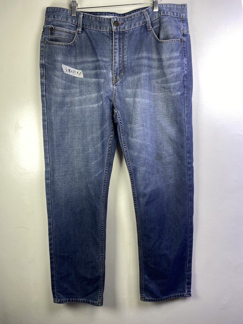 Burberry Blue Denim Jeans (Category: Jeans) located in Manila. Submitted by declutterpromax (Listing ID 1464601055, Image 1). Description: - Classic blue denim jeans - Straight leg fit - Fading on thighs and knees - Small stain on left thigh - Significant fraying and tear on right leg's bottom hem - Button fly closure.