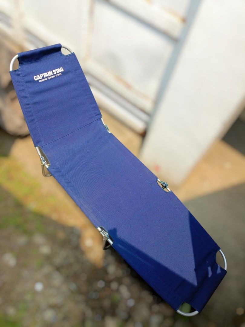 Captain Stag Blue Camping Cot Folding Bed (Category: Hiking & Camping) located in Valenzuela. Submitted by feel_lucky (Listing ID 1464732399, Image 1). Description: - Brand: Captain Stag - Color: Deep blue - Frame: Sturdy metal with secure-locking joints and hinges - Material: Durable fabric construction - Portability: Folds up compactly for easy transport and storage - Condition: Ready for your next outdoor adventure, camping trip, or backyard l