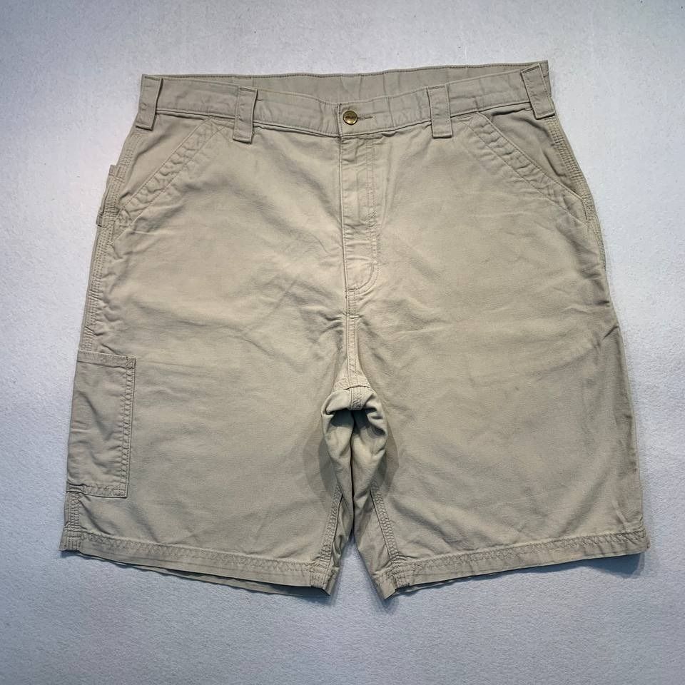 Carhartt B147 Tan Shorts (Category: Shorts) located in Mandaluyong City. Submitted by theroom501 (Listing ID 1464750129, Image 2). Description: Carhartt B147 Tan Shorts Style Code: B147 Tan Size on Tag: 36 Color: Tan Condition: Good pre-owned condition with visible signs of previous use. Flaws/Issues: Cut-off size tag, visible yellow stain, and peeling leather patch. Flat Lay Measurements: Pit to Pit: 36 inches Length: 21.5 inches Leegopening Len