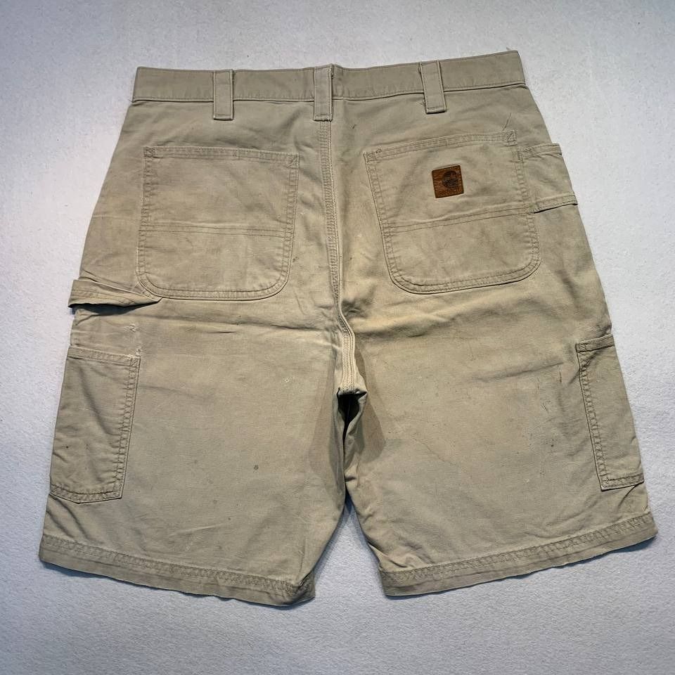Carhartt B147 Tan Shorts (Category: Shorts) located in Mandaluyong City. Submitted by theroom501 (Listing ID 1464752052, Image 1). Description: Carhartt B147 Tan Shorts Style Code: B147 Tan Size on Tag: 34 Color: Tan Condition: Good pre-owned condition with visible signs of previous use. Flaws/Issues: visible yellow stain, and peeling leather patch. Flat Lay Measurements: Pit to Pit: 34 inches Length: 21 inches Leegopening Length: 12 inches Price