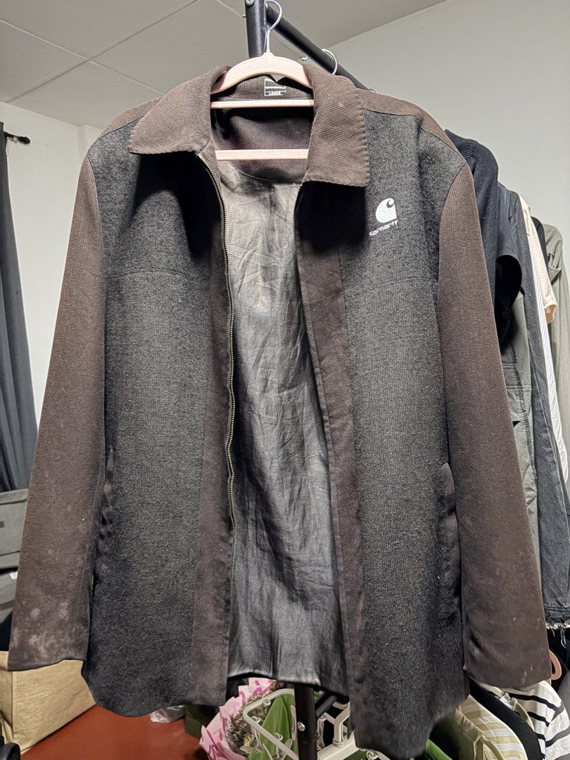 Carhartt Two-Tone Zip Jacket (Category: Coats, Jackets and Outerwear) located in Manila. Submitted by finderskeepersmnl_092026 (Listing ID 1464745048, Image 1). Description: - Brand: Carhartt - Style: Zip-up jacket with lapel collar - Color: Dark grey and brown - Size: Large (tag inside collar) - Material: 100% cotton with structured ribbed texture - Details: Classic Carhartt logo on chest pocket area, full front metal zipper closure - Condition: