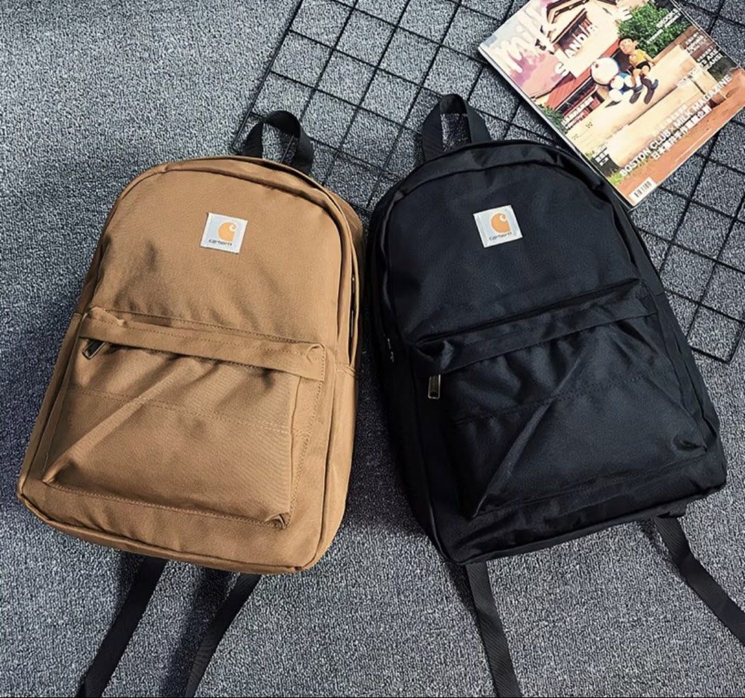Carhatt Basic Backpack (Category: Backpacks) located in Singapore. Submitted by eth4nn._ (Listing ID 1464747884, Image 6). Description: - Color: Black/Brown -Preorder: 1-2 weeks, 50% deposit required - Material: Sturdy canvas - Storage: Front zip pocket - Details: Branded metal zipper pulls & woven Carhartt logo patch - Comfort: Padded shoulder straps - Condition: Brand new / Excellent daily use design.