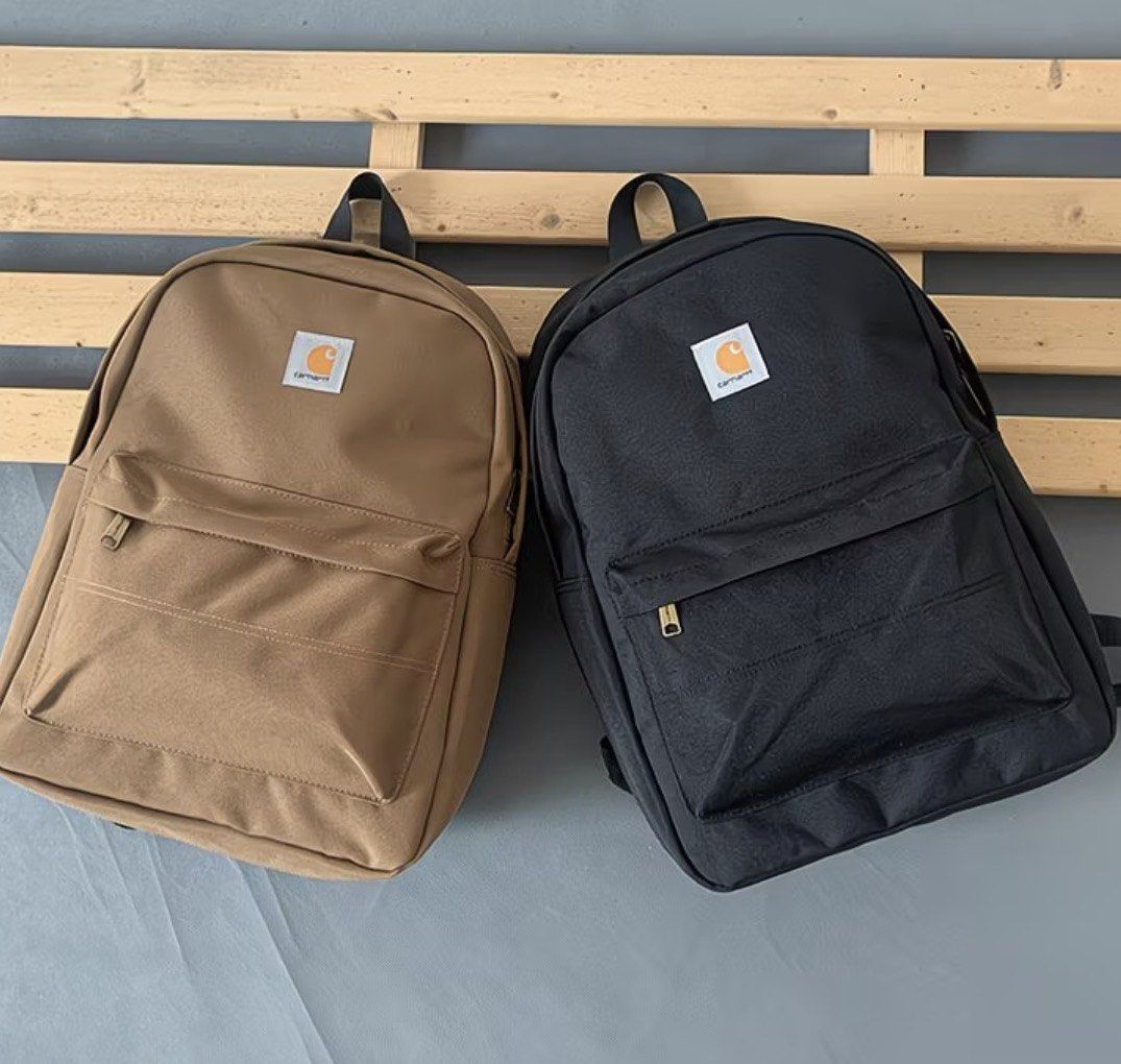 Carhatt Basic Backpack (Category: Backpacks) located in Singapore. Submitted by eth4nn._ (Listing ID 1464747884, Image 3). Description: - Color: Black/Brown -Preorder: 1-2 weeks, 50% deposit required - Material: Sturdy canvas - Storage: Front zip pocket - Details: Branded metal zipper pulls & woven Carhartt logo patch - Comfort: Padded shoulder straps - Condition: Brand new / Excellent daily use design.
