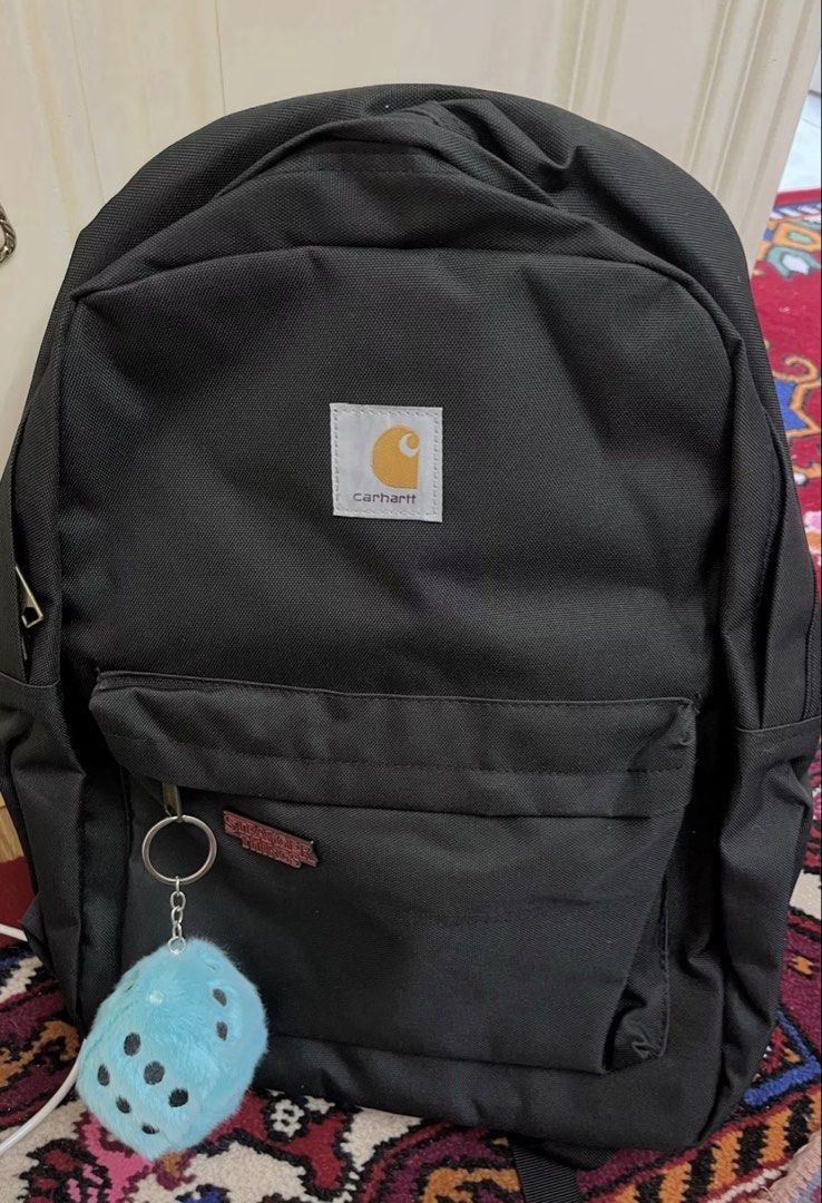 Carhatt Basic Backpack (Category: Backpacks) located in Singapore. Submitted by eth4nn._ (Listing ID 1464747884, Image 2). Description: - Color: Black/Brown -Preorder: 1-2 weeks, 50% deposit required - Material: Sturdy canvas - Storage: Front zip pocket - Details: Branded metal zipper pulls & woven Carhartt logo patch - Comfort: Padded shoulder straps - Condition: Brand new / Excellent daily use design.