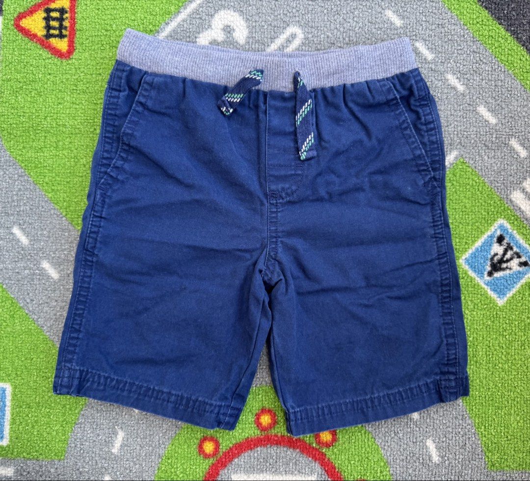 Carter’s Shorts (Category: Babies & Kids Fashion) located in Rizal. Submitted by preloovved (Listing ID 1464708583, Image 1). Description: Preloved, 4yo Comfortable solid blue cotton shorts for little boys, featuring a grey ribbed elastic waistband, decorative drawstring, and two front pockets. Perfect for casual everyday wear in warmer weather. C-2.