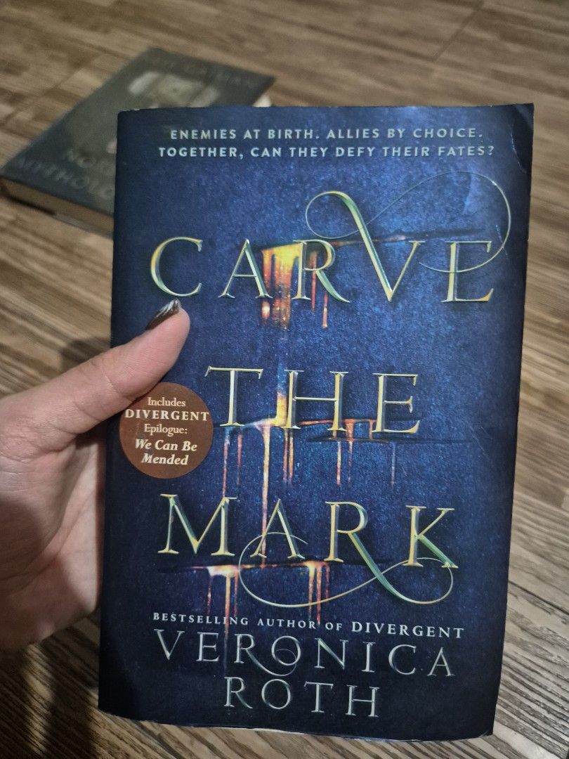 Carve the Mark by Veronica Roth Novel (Category: Storybooks) located in Manila. Submitted by abianne (Listing ID 1464724661, Image 1). Description: - Title: Carve the Mark by Veronica Roth - Format: Paperback - Special Feature: Includes the Divergent epilogue 'We Can Be Mended' - Condition: Readable copy with yellowing, foxing, and minor shelf wear around the edges.