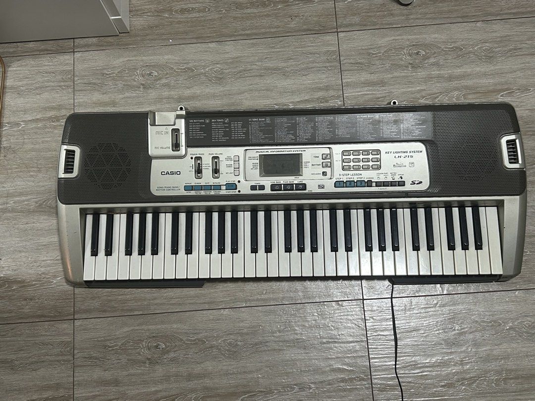 Casio LK-215 Electronic Keyboard with Key Lighting System (Category: Musical Instruments) located in Quezon City. Submitted by javi_agbayani (Listing ID 1464596400, Image 1). Description: - Casio CTK-2100 Keyboard - 61 Keys with Key Lighting System - Wide variety of Tones and Rhythms - Built-in Lesson Functions - Ideal for Learning or Casual Play - Power Adapter Included (not pictured) - Fully Functional and Works Well - RFS: Need Funds - MOP: Gc