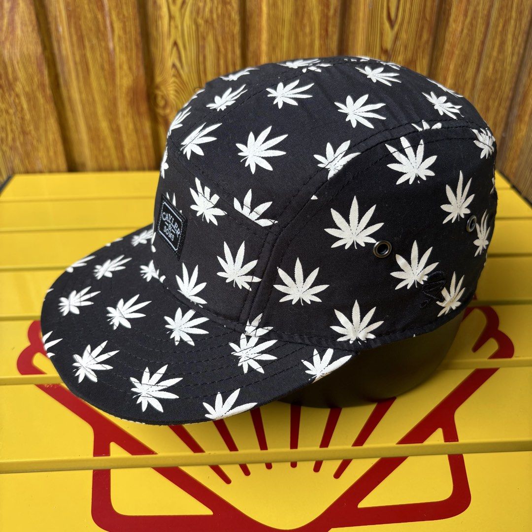 Cayler & Sons 5 Panel Cap - Black with White Leaf Pattern (Category: Caps & Hats) located in Dapitan. Submitted by payt3es_thrift. (Listing ID 1464601874, Image 3). Description: - Brand: Cayler & Sons - Style: 5 panel cap - Color: Black - Design: All-over white leaf print - Features: Classic Cayler & Sons tag on front, adjustable strap at the back - Ideal for: Everyday wear.