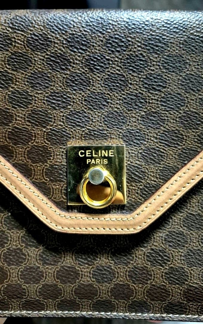 Celine Macadam Pattern Clutch Bag (Category: Clutches) located in Muntinlupa City. Submitted by coolstorm.2026 (Listing ID 1464585817, Image 2). Description: - Iconic Celine Macadam print in brown and tan. - Genuine leather trim and gold-tone hardware. - Secure snap button closure on the front flap. - Interior zip pocket for organized storage. - Celine Paris Made in Italy leather tag. - Compact and perfect for carrying your daily essentials. Othe