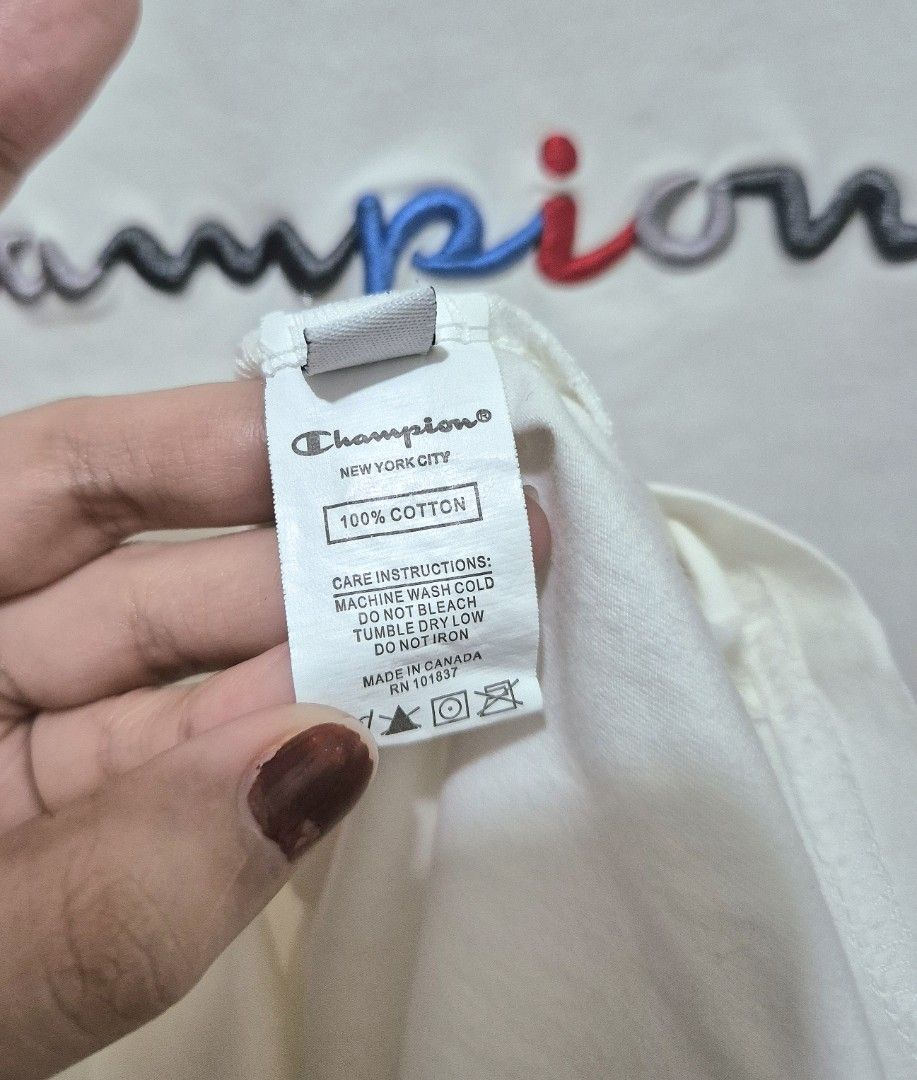 Champion Embroidered Logo Tee (Category: Shirts) located in San Mateo. Submitted by sellbypelle (Listing ID 1464660675, Image 2). Description: Brand: Champion Made in Canada Actual Measurements W: 19 inch (38 bust) stretchable L : 27 Issue: Broken line thread sa may neckline (see photo 4). Pero may double stitching sa loob, kaya hindi naman nakabukas tahi. Location: Rizal 💰 Payment: GCash — pay first 📦 Shipping: + sf via J&T only 🗓️ Batch ship