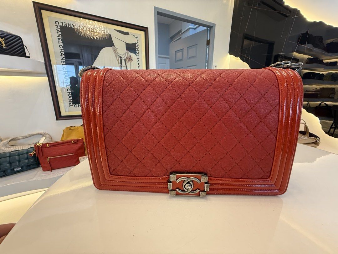 Chanel Boy Bag Red Quilted Leather Handbag (Category: Luxury Bags & Wallets) located in Alfonso. Submitted by luxurose (Listing ID 1464759750, Image 2). Description: - Authentic Chanel Boy bag in vibrant red quilted leather - Chunky ruthenium chain strap with comfortable leather shoulder guard - Signature CC push-lock clasp in brushed silver hardware - Clean red fabric interior with practical open pocket space - Stylish patent leather trim detail