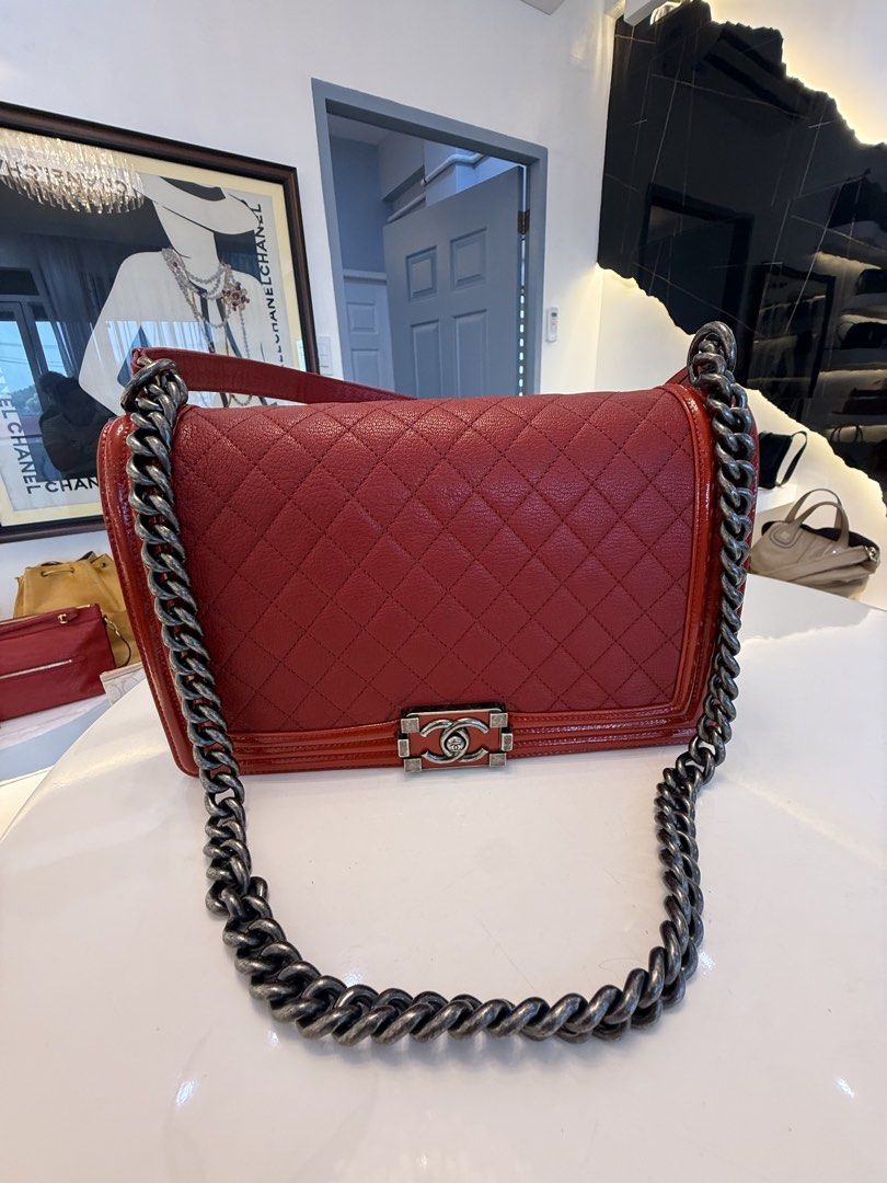 Chanel Boy Bag Red Quilted Leather Handbag (Category: Luxury Bags & Wallets) located in Alfonso. Submitted by luxurose (Listing ID 1464759750, Image 1). Description: - Authentic Chanel Boy bag in vibrant red quilted leather - Chunky ruthenium chain strap with comfortable leather shoulder guard - Signature CC push-lock clasp in brushed silver hardware - Clean red fabric interior with practical open pocket space - Stylish patent leather trim detail