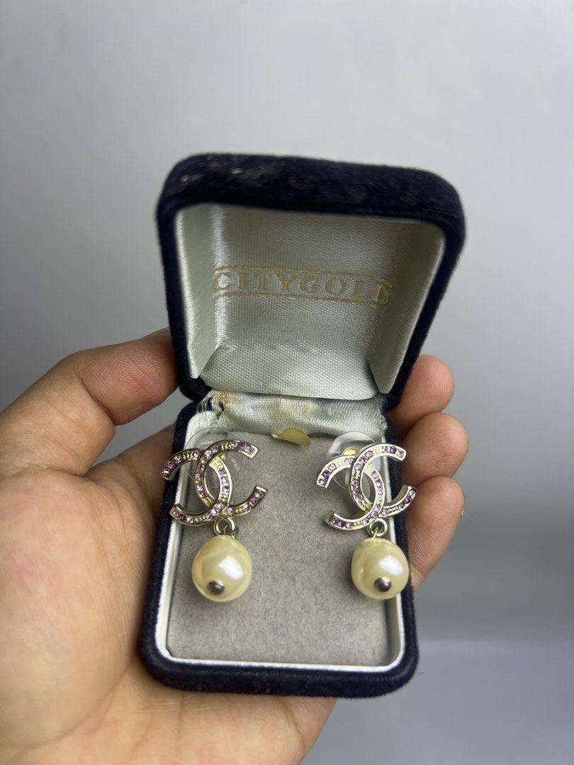 Chanel CC Logo Crystal Pearl Dangle Earrings (Category: Earrings) located in Baguio. Submitted by chiechie1234 (Listing ID 1464689322, Image 1). Description: - Brand: Chanel - Design: CC logo with pink crystals and dangling faux pearls - Hardware: Gold-tone - Details: Hallmark stamp on the back, secure post back closure with plastic backs - Condition: Clean, all crystals fully intact .