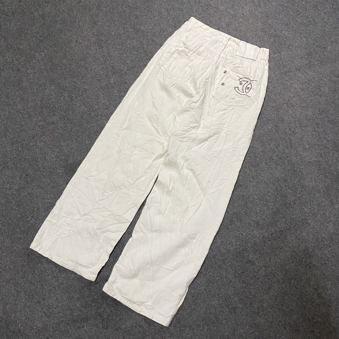 Chanel White Wide Leg Pants (Category: Jeans) located in Cebu City. Submitted by callmejasonx (Listing ID 1464658253, Image 2). Description: - Authentic Chanel white wide leg pants - Classic design with iconic CC logo embroidered on back pocket - Front button and zip closure - Comfortable and stylish, perfect for versatile styling -Waist 26 -Lenght 39 -Hem 9.5.