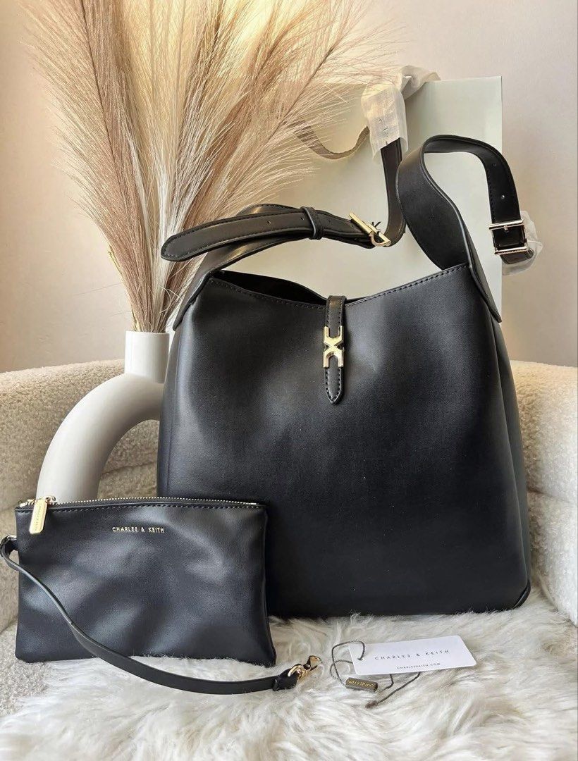 Charles & Keith Adalyn Hobo Bag - Black (Category: Shoulder Bags) located in Pasig City. Submitted by preloved.closet2 (Listing ID 1464763339, Image 1). Description: Hobo Bag with Pouch Extra Shoulder strap Size large Can fit ipad Color Black Add paperbag plus 80.