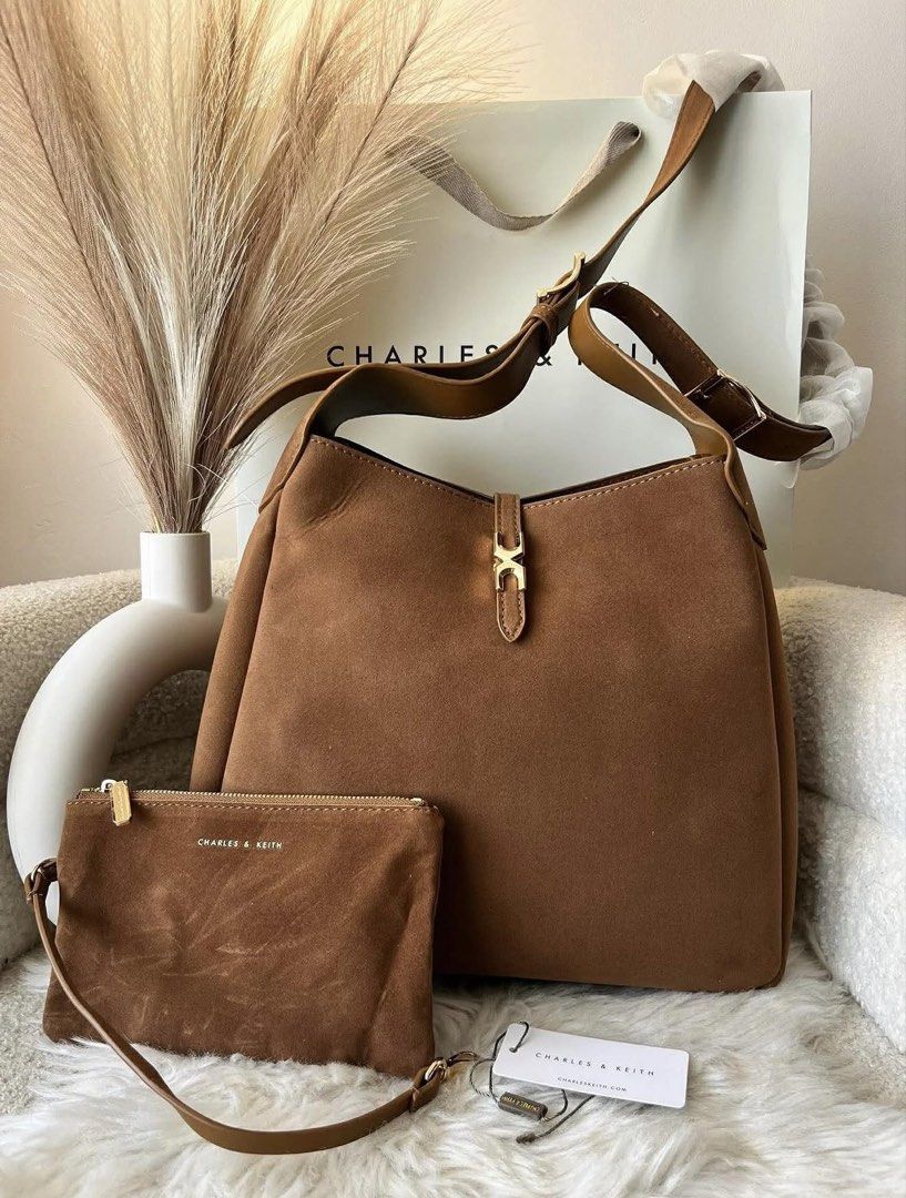 Charles & Keith Adalyn Suede Hobo Bag (Category: Shoulder Bags) located in Pasig City. Submitted by preloved.closet2 (Listing ID 1464763140, Image 1). Description: Hobo Bag with Pouch Extra Shoulder strap Size large Can fit ipad Suede Brown Color Add paperbag plus 80.