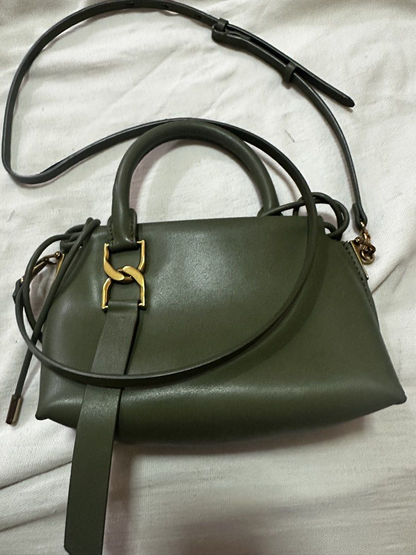Charles & Keith Olive Green Top Handle Bag (Category: Luxury Bags & Wallets) located in Manila. Submitted by the_maria_shop (Listing ID 1464632913, Image 2). Description: - Olive green Charles & Keith top handle bag - Includes a detachable crossbody strap - Elegant gold hardware details - Interior features a small pocket - Secure drawstring closure - Ideal for everyday wear.