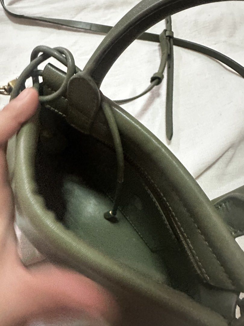 Charles & Keith Olive Green Top Handle Bag (Category: Luxury Bags & Wallets) located in Manila. Submitted by the_maria_shop (Listing ID 1464632913, Image 1). Description: - Olive green Charles & Keith top handle bag - Includes a detachable crossbody strap - Elegant gold hardware details - Interior features a small pocket - Secure drawstring closure - Ideal for everyday wear.