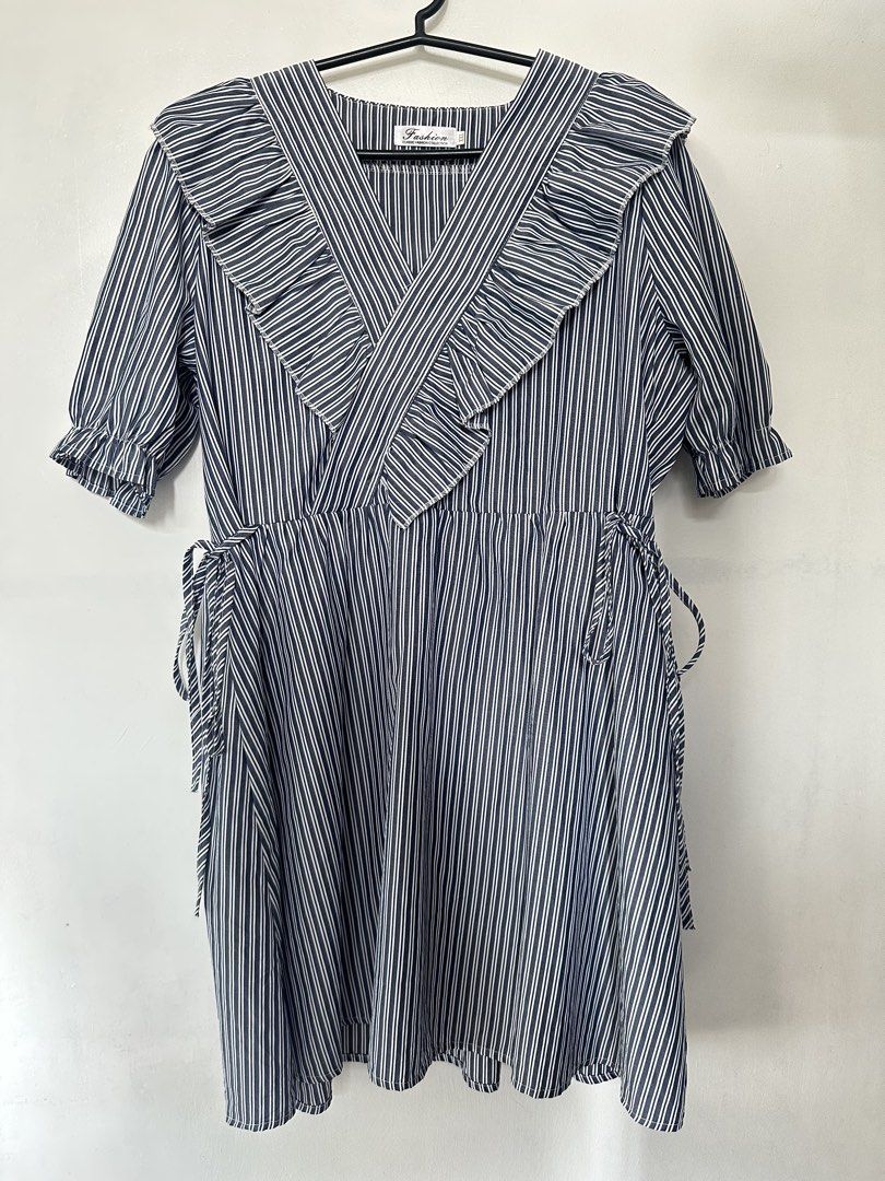 Chic Striped V-Neck Ruffle Mini Dress (Category: Dresses) located in Taguig. Submitted by closetbyenya (Listing ID 1464632733, Image 1). Description: Description: Add a stylish touch to your outfit with this navy blue and white pinstriped midi/mini dress! Designed with a flattering wrap-style V-neckline framed by statement ruffles, puffed short sleeves with elastic cuffs, and side tie accents at the waist. Perfectly combines feminine elegance wit
