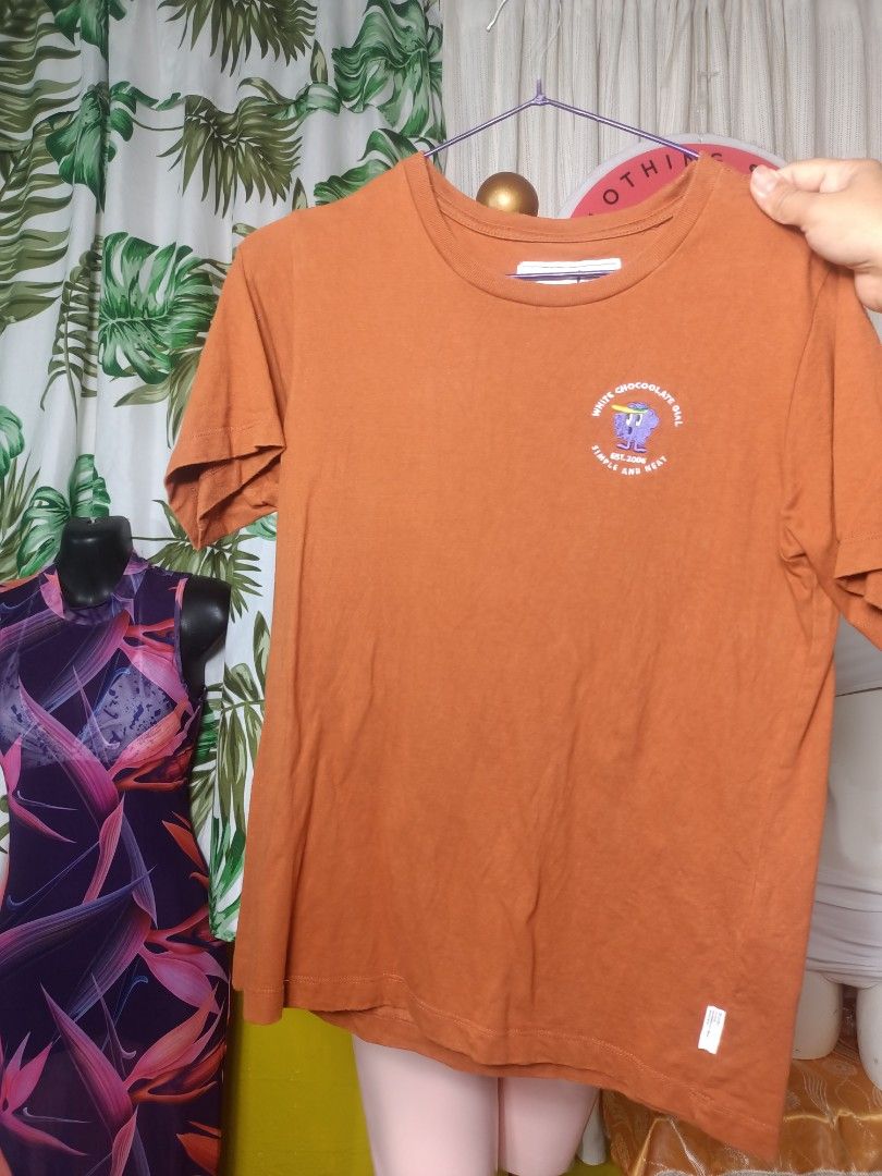 CHOCOOLATE Brown Short Sleeve Graphic Tee Size XS (Category: Shirts) located in Manila. Submitted by jonahq.9 (Listing ID 1464691851, Image 3). Description: - Brand::CHOCOOLATE - Size: Extra Small (XS) - Color: Brown - Design: Small embroidered purple chest graphic with white text ("WHITE CHOCOOLATE GIRL est. 2006 SIMPLE AND NEAT") - Material: Soft and comfortable cotton - Details: Crew neck, short sleeves, clean collar tag.