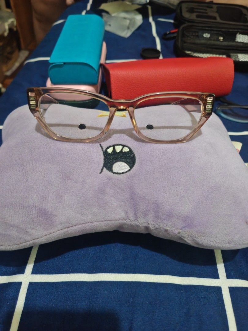 Clear Lens Eyeglasses with Case (Category: Sunglasses & Eyewear) located in Quezon City. Submitted by jk1225777 (Listing ID 1464615385, Image 3). Description: - Clear, non-prescription lenses - Light pinkish-brown frame color - Includes a protective black hard case - Ideal for everyday wear or as a fashion accessory - Ready for a new owner! RFS: decluttering, needs new lens (this has grade reading) used 1x.