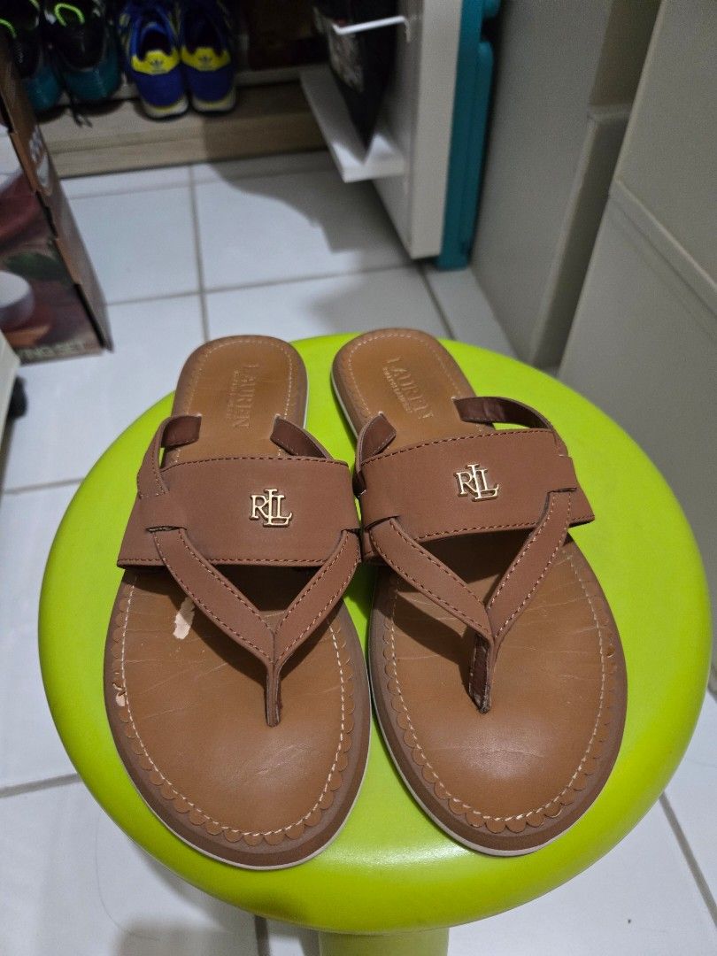 Coach & Lauren Ralph Lauren Brown Sandals Declutter (Category: Flats & Sandals) located in Quezon City. Submitted by mgdeclutters (Listing ID 1464599164, Image 2). Description: - Two pairs of stylish flip-flop sandals, perfect for casual wear. - One pair is Coach, featuring the signature 'C' logo. - The other pair is Lauren Ralph Lauren, showcasing the 'RL' logo. - Both pairs are size 7 (US Women's). - Please see picture for the flaws..