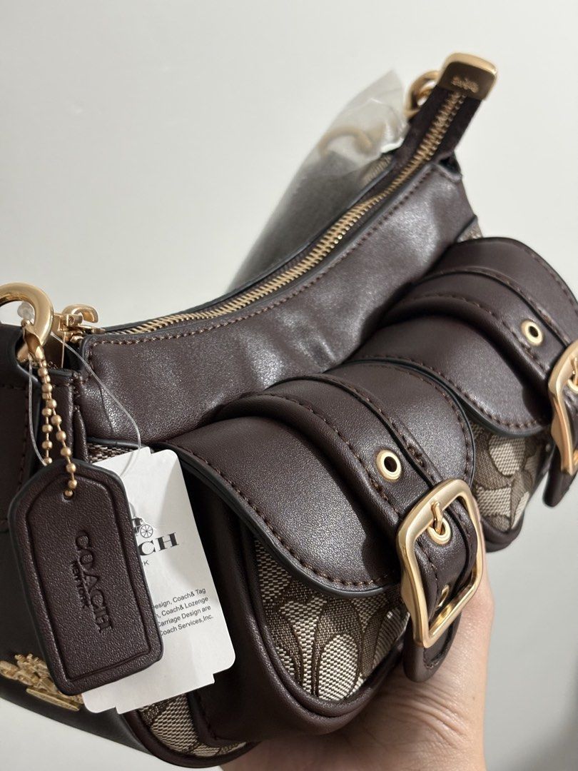 Coach Ashton Bag (Category: Luxury Bags & Wallets) located in Abucay. Submitted by erindeclutterss (Listing ID 1464579696, Image 3). Description: drop your offerss 🫶 - Brand new - Auth viet variant - Gold hardware and buckle details on front pockets - Includes original tags.