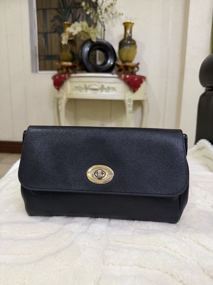Coach Black Crossbody Bag with Turnlock Closure (Category: Cross-body Bags) located in Meycauayan. Submitted by sweet.cherry.ph (Listing ID 1464723833, Image 1). Description: - Brand: Coach - Material: Textured pebbled leather in classic black - Hardware: Elegant gold-tone accents - Closure: Signature turnlock front closure - Strap: Adjustable matching black leather strap - Storage: Convenient back slip pocket and clean interior - Condition: Grea
