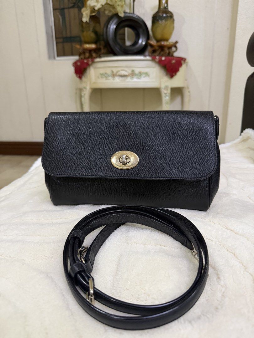 Coach Black Crossbody Bag with Turnlock Closure (Category: Cross-body Bags) located in Meycauayan. Submitted by sweet.cherry.ph (Listing ID 1464723833, Image 2). Description: - Brand: Coach - Material: Textured pebbled leather in classic black - Hardware: Elegant gold-tone accents - Closure: Signature turnlock front closure - Strap: Adjustable matching black leather strap - Storage: Convenient back slip pocket and clean interior - Condition: Grea