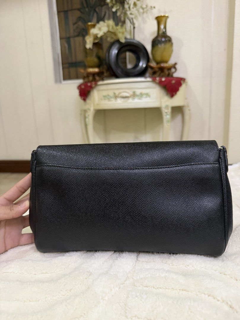 Coach Black Crossbody Bag with Turnlock Closure (Category: Cross-body Bags) located in Meycauayan. Submitted by sweet.cherry.ph (Listing ID 1464723833, Image 3). Description: - Brand: Coach - Material: Textured pebbled leather in classic black - Hardware: Elegant gold-tone accents - Closure: Signature turnlock front closure - Strap: Adjustable matching black leather strap - Storage: Convenient back slip pocket and clean interior - Condition: Grea